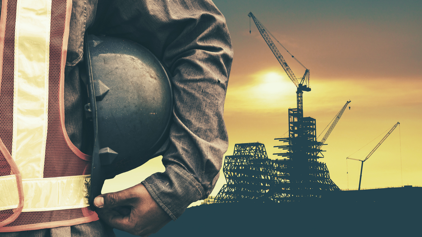 construction worker checking location site with crane on the background construction worker checking location site with crane on the background