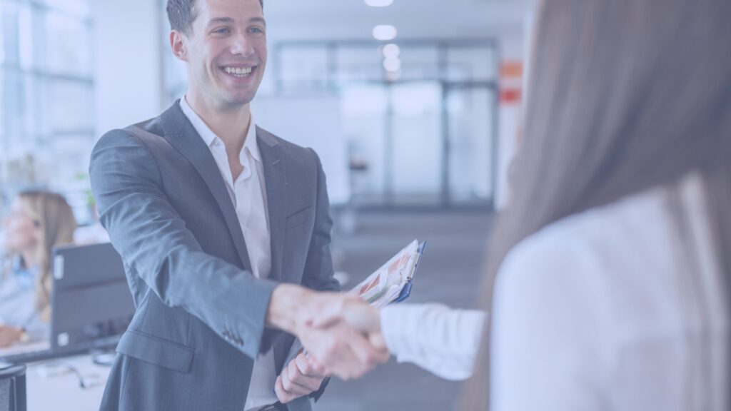 Job candidate shaking hands with an interviewer, preparing for a successful job interview at ResponsAble Staffing.