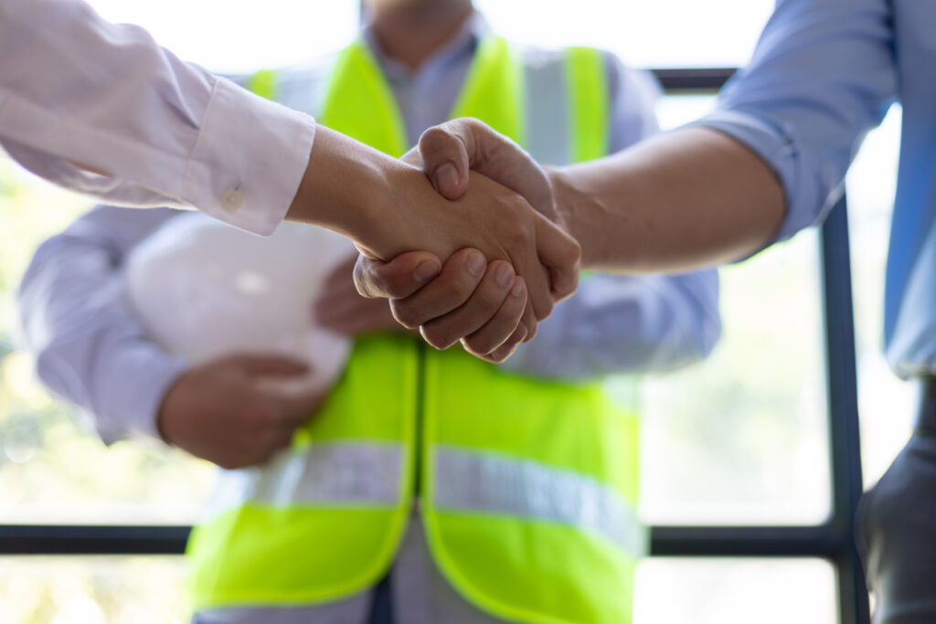 Safety manager hired through direct hire EHS staffing reviews site plans with foreman at construction project