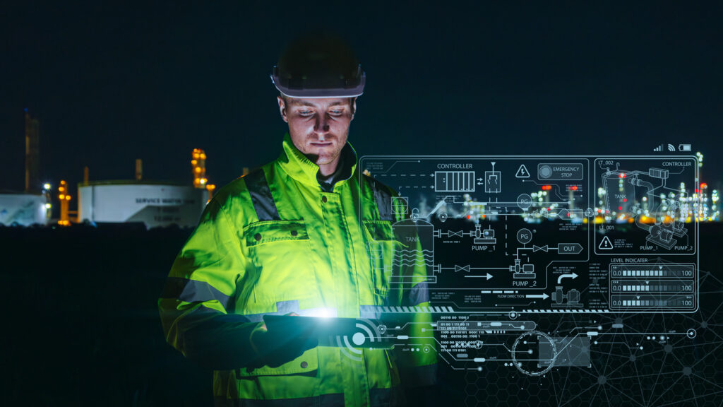 Modern technology oil and gas refinery engineer worker using advance digital device monitor service in petroleum industry pipe plant. stock photo