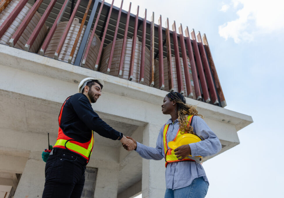 Engineering and foreman shaking hands on construction site and A Engineering and foreman shaking hands on construction site and Agree. partnership and connection. Architect building supervising and inspector deal successful.