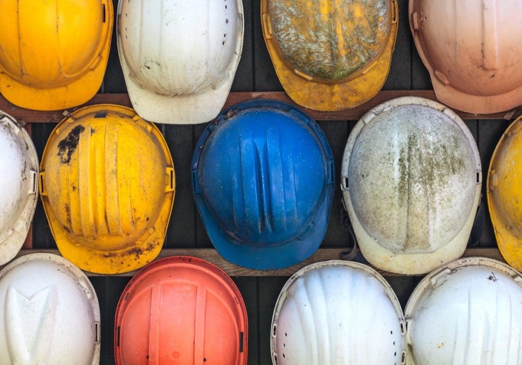 Old and worn colorful construction helmets