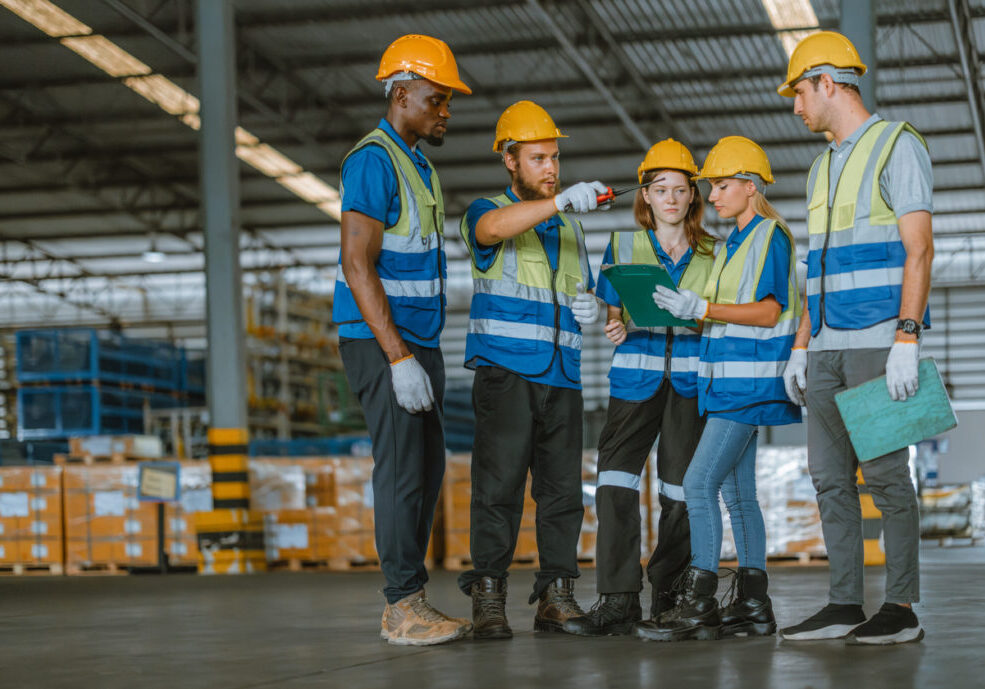 Multicultural warehouse staff creates logistical atmosphere that encourages empowerment, confidence. The collaborative and diverse team results in excellent performance and a strong sense of unity.