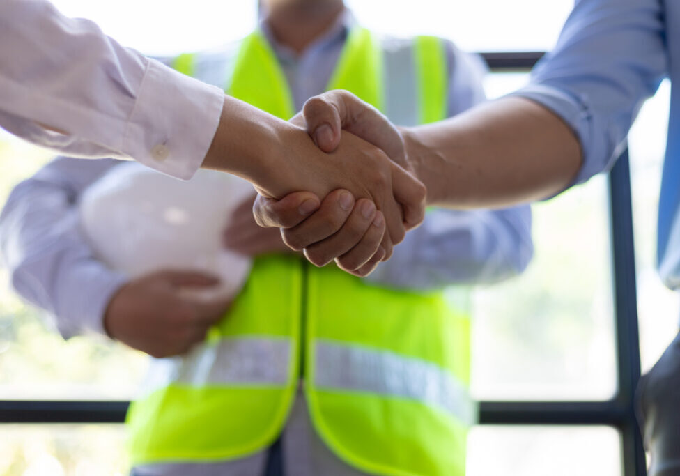 Direct Hire EHS Staffing – New Safety Manager On Site Safety manager hired through direct hire EHS staffing reviews site plans with foreman at construction project