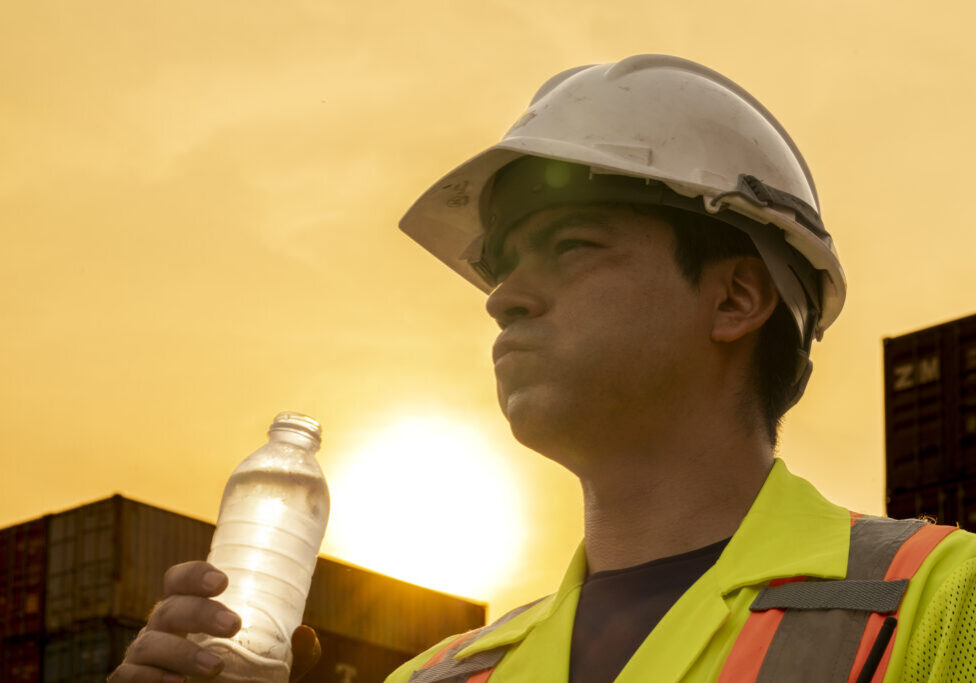 logistics workers people working to operation on site containers logistics workers man drinking water on site area operations at a busy shipping container yard at sunset. successful coordination in freight, transportation, and supply chain operations